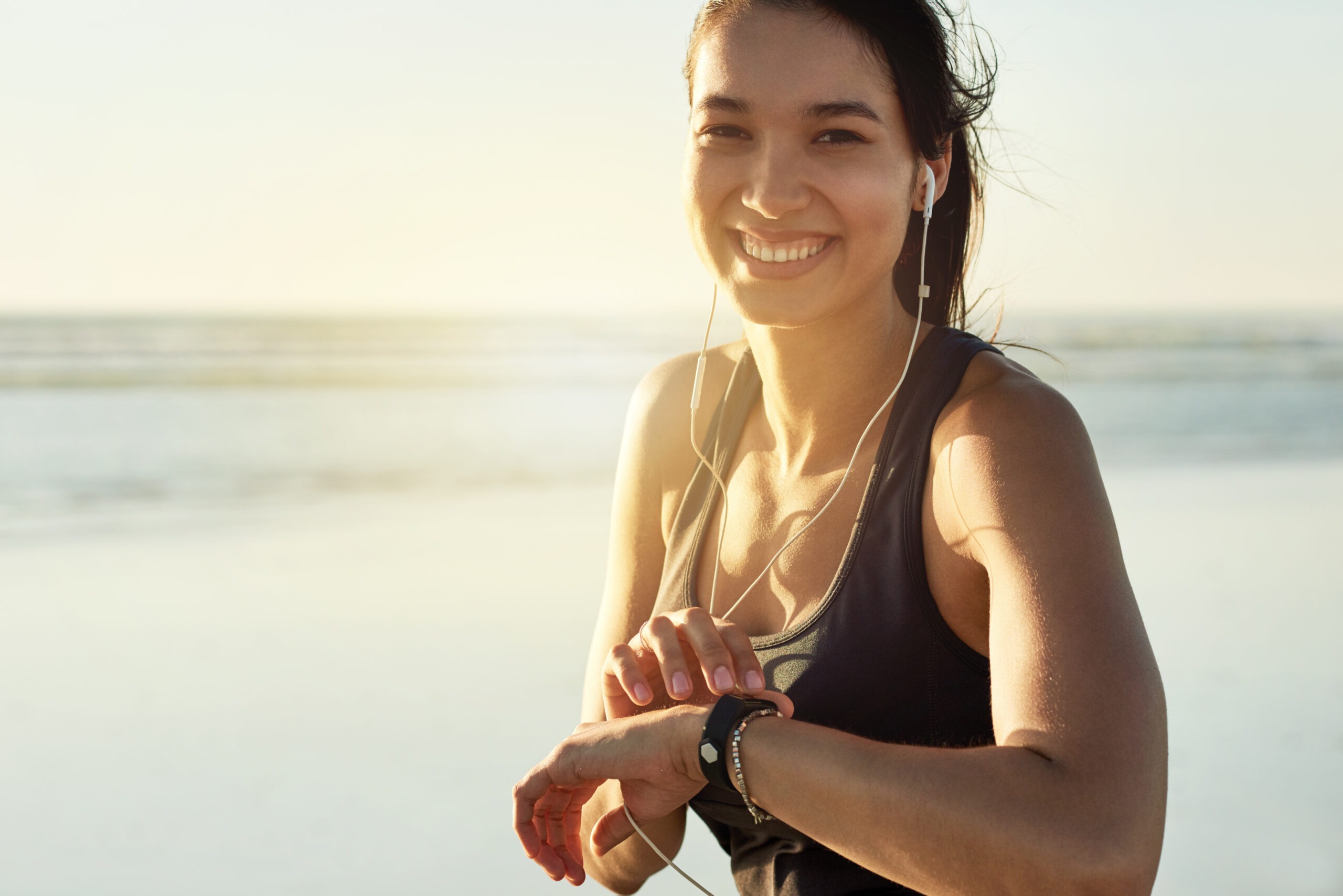 Young woman working out on the beach.